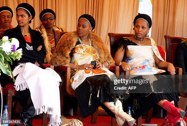 Three of Swaziland's King Mswati III's wives look at their husband delivering a speech on July 15, 2011 in Mankayane. Swaziland's King Mswati III...