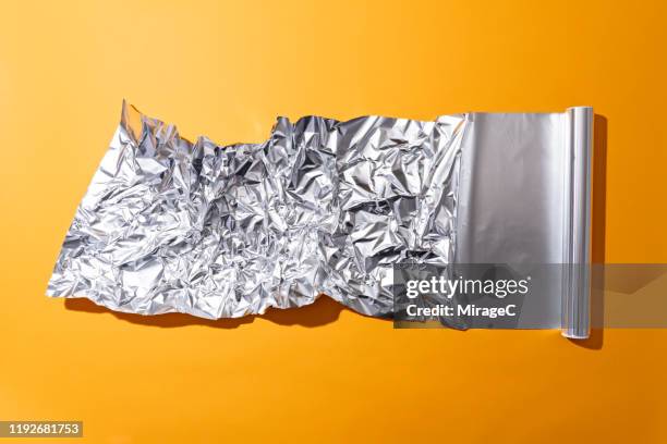crumpled aluminium foil roll - foil fotografías e imágenes de stock