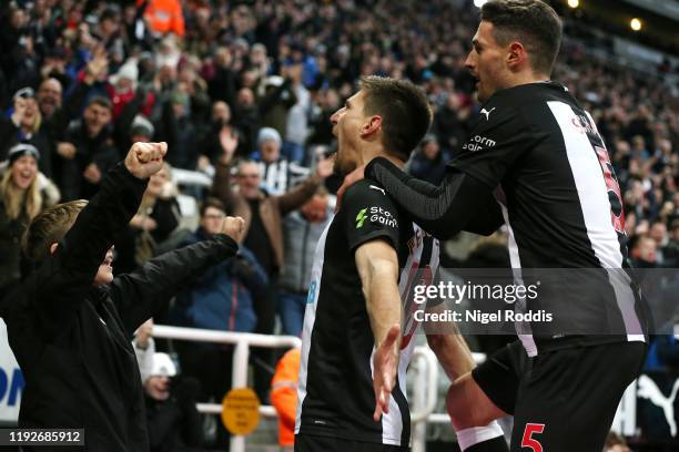 Federico Fernandez of Newcastle United celebrates with teammate Fabian Schar after scoring his team's second goal during the Premier League match...