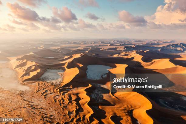aerial view of sossusvlei sand dunes at sunrise, namibia - dead vlei stockfoto's en -beelden