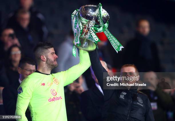 Fraser Forster of Celtic lifts the Betfred Cup with Neil Lennon, Manager of Celtic after the Betfred Cup Final between Rangers FC and Celtic FC at...