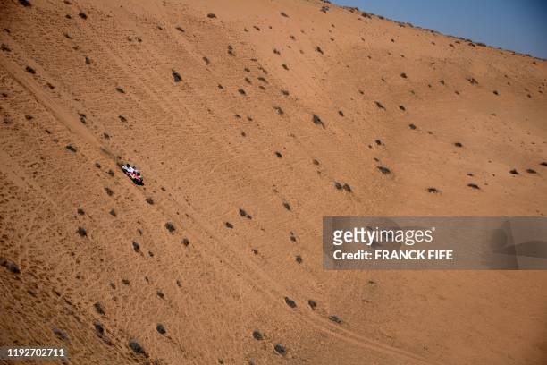 Toyota's driver Nasser al-Attiyah of Qatar and his co-driver Mathieu Baumel of France compete during the Stage 5 of the Dakar 2020 between Al Ula and...