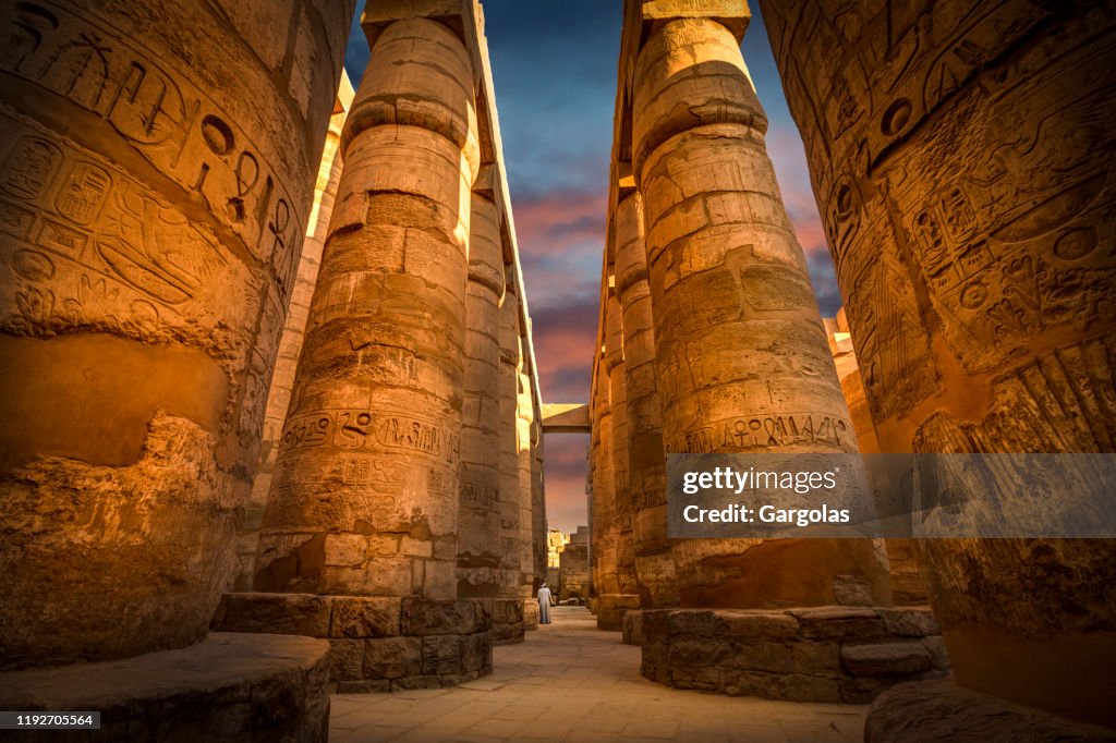 Ancient ruins of Karnak temple with colorful sky, Egypt