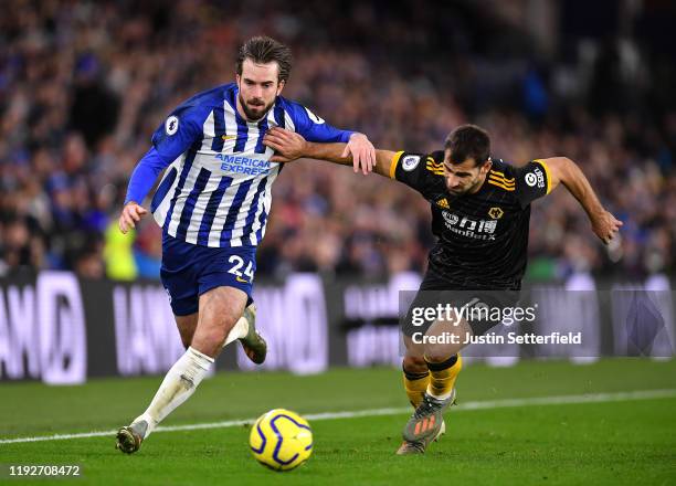 Davy Propper of Brighton and Hove Albion challenges for the ball with Jonny Otto of Wolverhampton Wanderers during the Premier League match between...