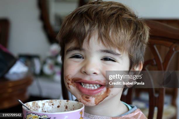 happy boy after eating cup of hot chocolate - mug cake stock pictures, royalty-free photos & images