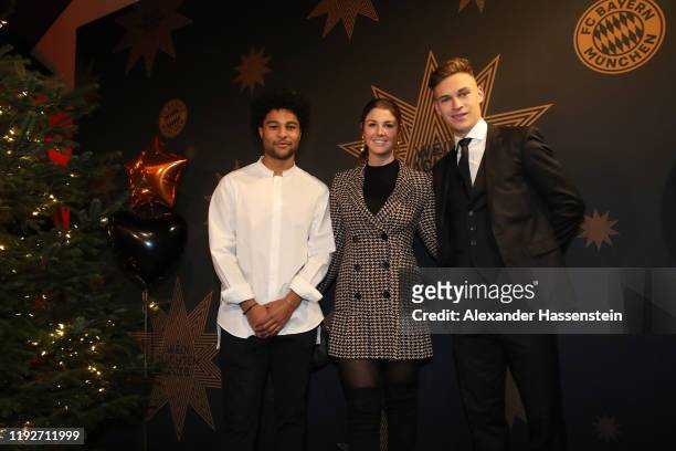Serge Gnabry attends with team mate Joshua Kimmich of FC Bayern Muenchen and Lina Meyer the clubs Christmas party at Allianz Arena on December 08,...