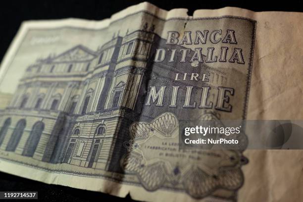 Two old Italian Lira currency banknotes are displayed on a black background in Milan, Italy, on 09 January 2020. The Italian Lira was the Italian...