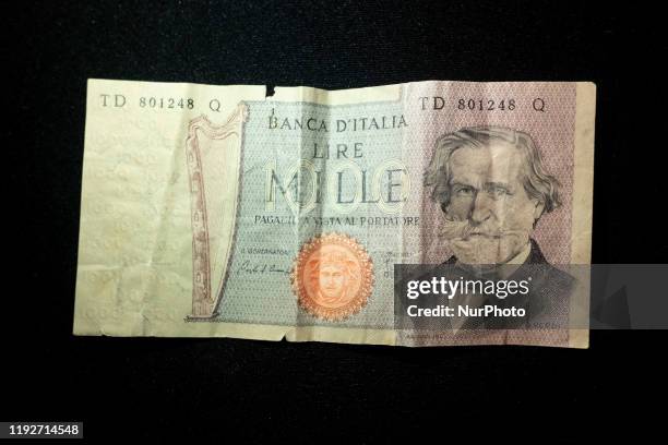 Two old Italian Lira currency banknotes are displayed on a black background in Milan, Italy, on 09 January 2020. The Italian Lira was the Italian...