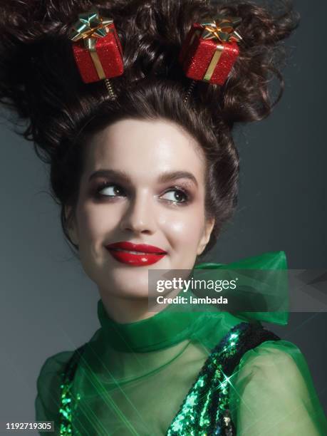 young woman wearing christmas presents headband - crazy holiday models stock pictures, royalty-free photos & images