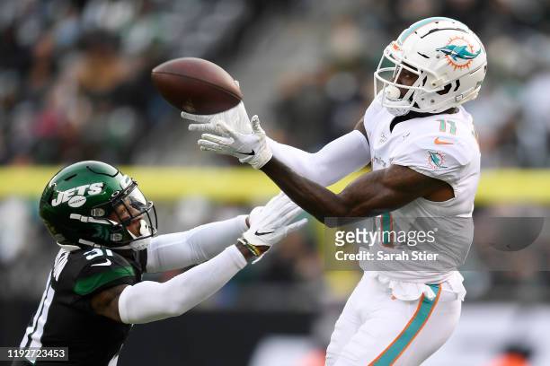 DeVante Parker of the Miami Dolphins catches the ball as Blessuan Austin of the New York Jets defends during the first half of the game at MetLife...