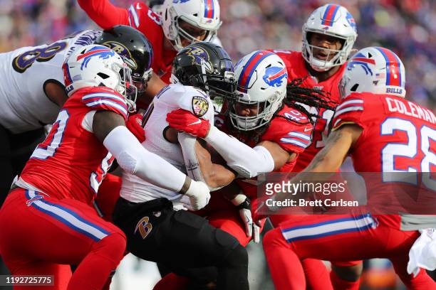 Tremaine Edmunds of the Buffalo Bills tackles Mark Ingram II of the Baltimore Ravens during the first half in the game at New Era Field on December...