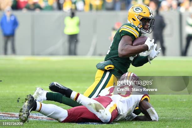 Strong safety Adrian Amos of the Green Bay Packers intercepts a pass intended for wide receiver Kelvin Harmon of the Washington Redskins during the...