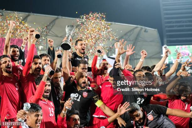 Bahrain captain Sayed Mohammed Jaffer lifts the Gulf Cup trophy as his teammates celebrate after their 1-0 win over Saudi Arabia at the Abdullah bin...