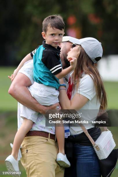 Justin Timberlake kisses his wife Jessica Biel on the cheek whilst he's holding their son Silas ahead of the Pro-Am prior to the start of the Omega...