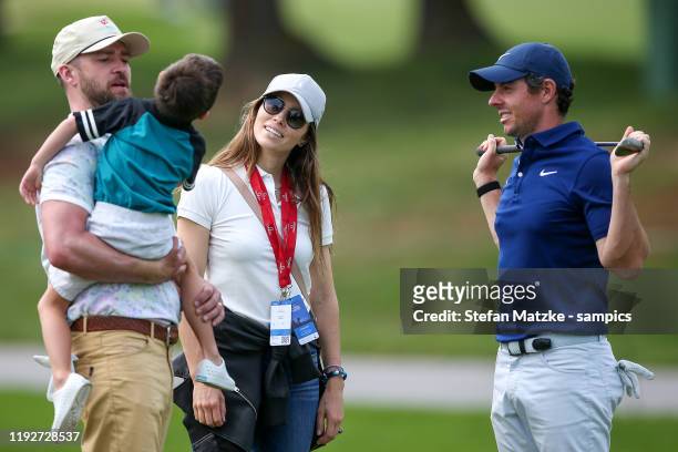 Justin Timberlake holds his son Silas whilst talking to his wife Jessica Biel and Rory McIlroy of Northern Ireland ahead of the Pro-Am prior to the...