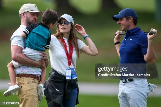 Justin Timberlake holds his son Silas whilst talking to his wife Jessica Biel and Rory McIlroy of Northern Ireland ahead of the Pro-Am prior to the...