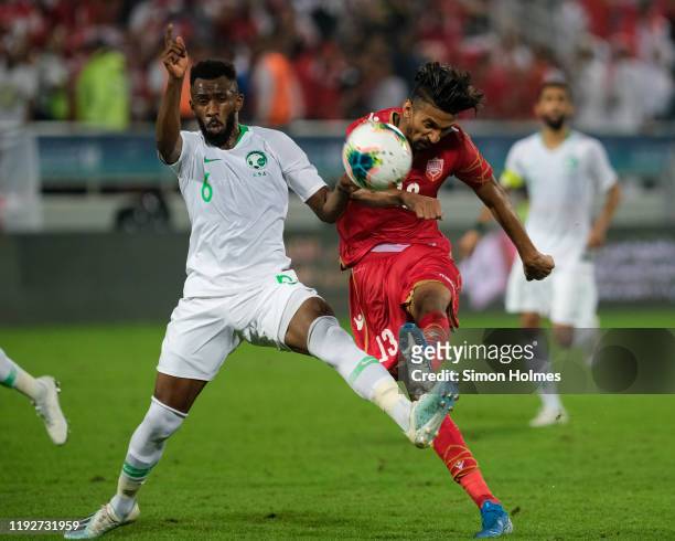 Bahrain's Mohamed Al-Rumaihi shoots at goal as Talal Al-Absi of Saudi Arabia tries to block during the Gulf Cup final between Bahrain and Saudi...