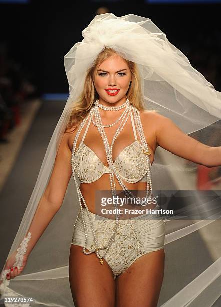 Kate Upton walks the runway at the Beach Bunny Swimwear show during Merecdes-Benz Fashion Week Swim 2012 at The Raleigh on July 15, 2011 in Miami...