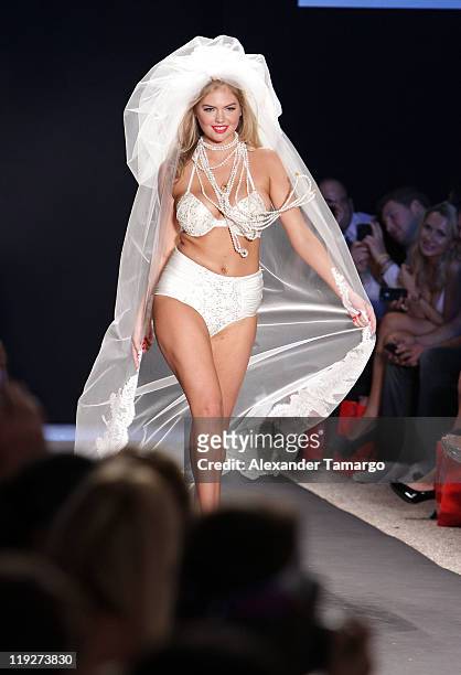 Model Kate Upton walks the runway at the Beach Bunny Swimwear show during Mercedes-Benz Fashion Week Swim 2012 at The Raleigh on July 15, 2011 in...