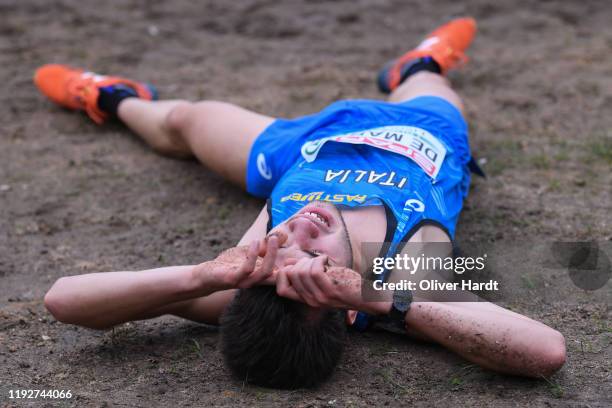 Jacopo de Marchi of Italy lies on the ground after his finished the U23 Men's race of the SPAR European Cross Country Championships at the Parque da...