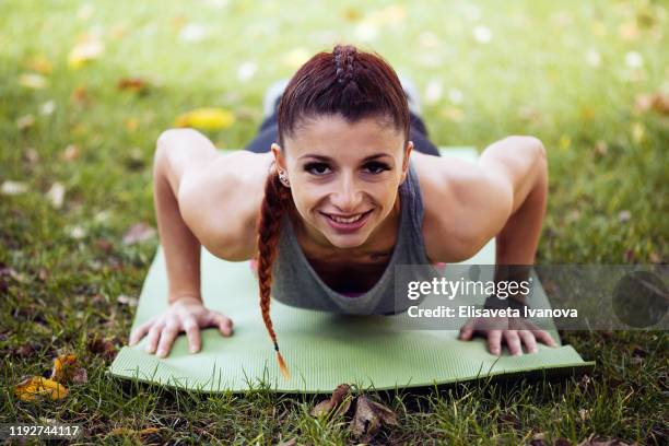 sportswoman doing push-ups - form fitted stock pictures, royalty-free photos & images