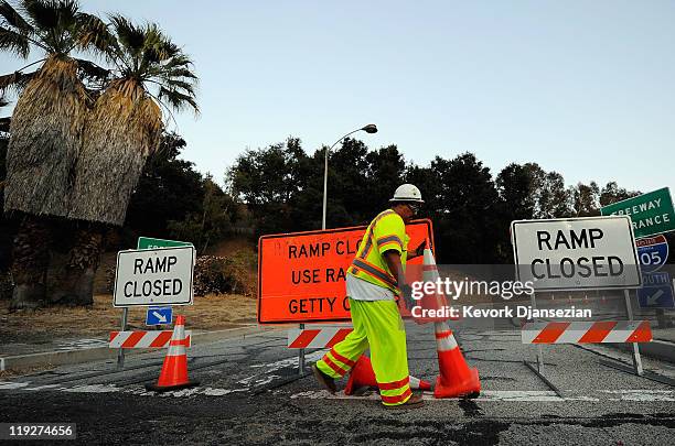 Construction workers shut down an on ramp to the Interstate 405 on Sepulveda Boluevard in the San Fernando Valley advising motorists of the shutdown...