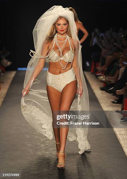 Kate Upton walks the runway at the Beach Bunny Swimwear show during Mercedes-Benz Fashion Week Swim at The Raleigh on July 15, 2011 in Miami Beach,...