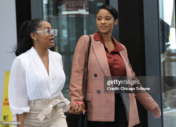 Kelly's girlfriends, left, Azriel Clary and Joycelyn Savage, leave following Kelly's hearing at the Leighton Criminal Court building, Sept. 17, 2019...