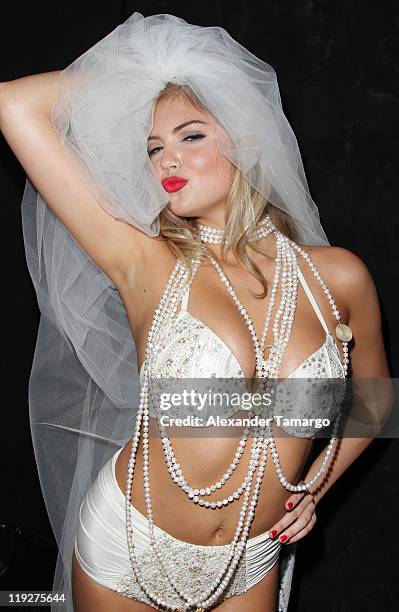 Model Kate Upton poses backstage at the Beach Bunny Swimwear show during Mercedes-Benz Fashion Week Swim 2012 at Raleigh Hotel on July 15, 2011 in...