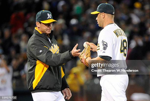 Manager Bob Melvin of the Oakland Athletics takes the ball from pitcher Michael Wuertz after Wuertz walked in a run against the Los Angeles Angels of...