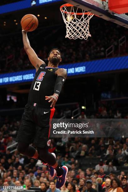 Paul George of the Los Angeles Clippers dunks against the Washington Wizards during the first half at Capital One Arena on December 8, 2019 in...