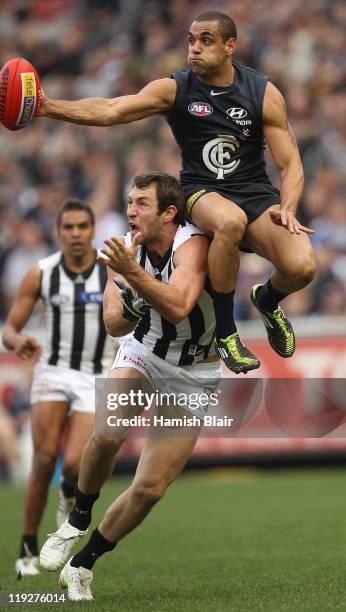 Chris Yarran of the Blues spoils a marking attempt of Travis Cloke of the Magpies during the round 17 AFL match between the Carlton Blues and the...