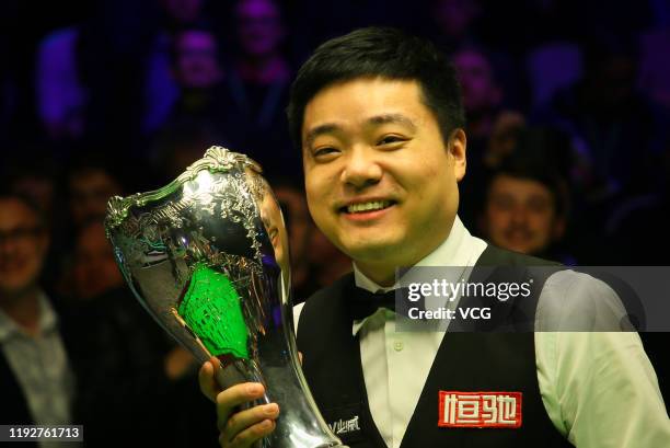 Ding Junhui of China celebrates with his trophy after winning the final match against Stephen Maguire of Scotland on day 13 of 2019 Betway UK...