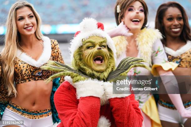 The Grinch poses with cheerleaders from the Jacksonville Jaguars before the start of a game against the Los Angeles Chargers at TIAA Bank Field on...