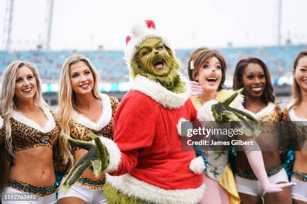 The Grinch poses with cheerleaders from the Jacksonville Jaguars before the start of a game against the Los Angeles Chargers at TIAA Bank Field on...