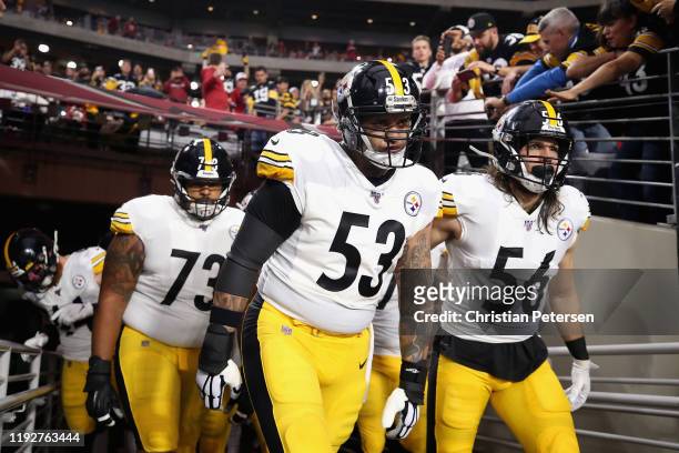 Center Maurkice Pouncey and linebacker Anthony Chickillo of the Pittsburgh Steelers lead teammates onto the field before the NFL game against the...