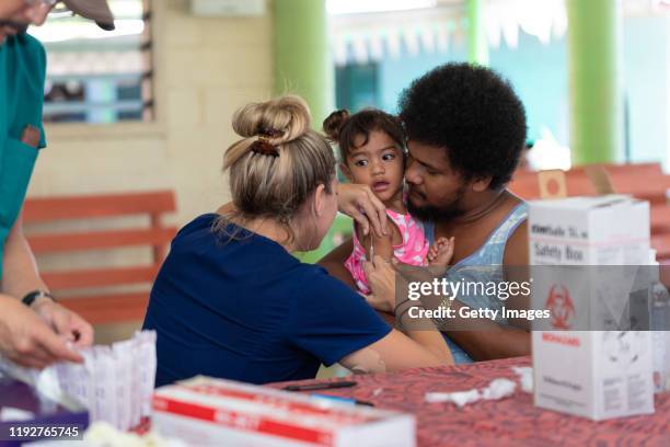 Hawaii aid workers help out with MMR vaccinations on December 6, 2019 in Apia, Samoa. Samoan officials report over 90% of eligible Samoans have been...