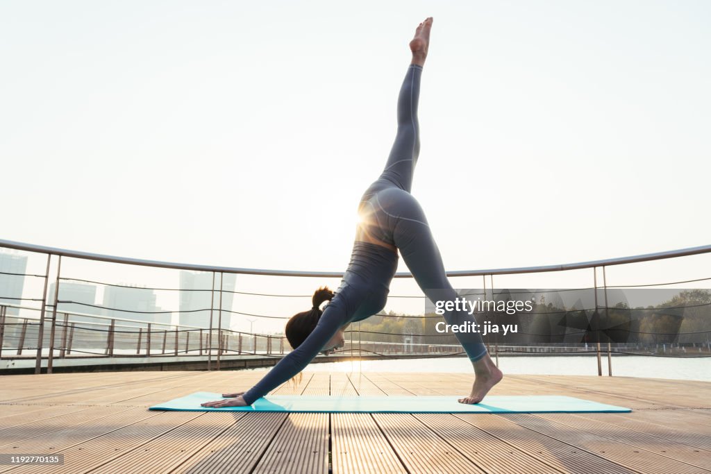 A young woman is practicing yoga.