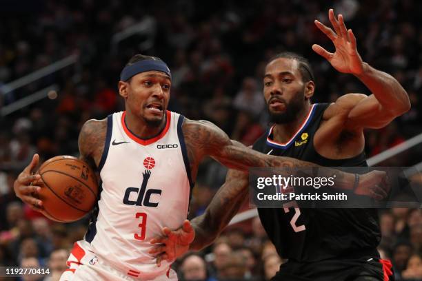 Bradley Beal of the Washington Wizards drives in the lane past Kawhi Leonard of the Los Angeles Clippers during the second half at Capital One Arena...