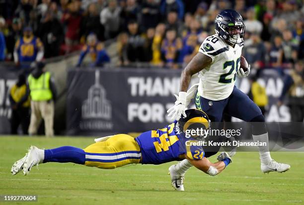 Running back Rashaad Penny of the Seattle Seahawks is tackled by safety Taylor Rapp of the Los Angeles Rams in the first quarter of the game at Los...