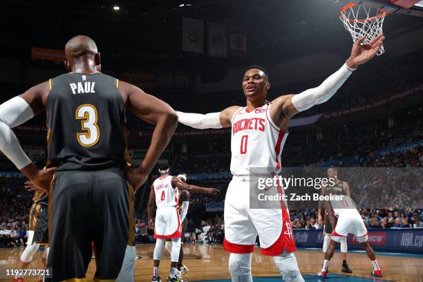 Russell Westbrook of the Houston Rockets guards Chris Paul of the Oklahoma City Thunder during the game on January 9, 2020 at Chesapeake Energy Arena...