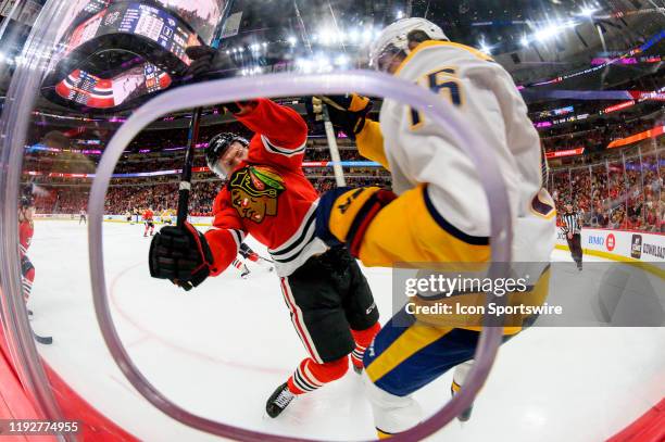 Nashville Predators right wing Craig Smith checks Chicago Blackhawks defenseman Slater Koekkoek during a game between the Nashville Predators and the...