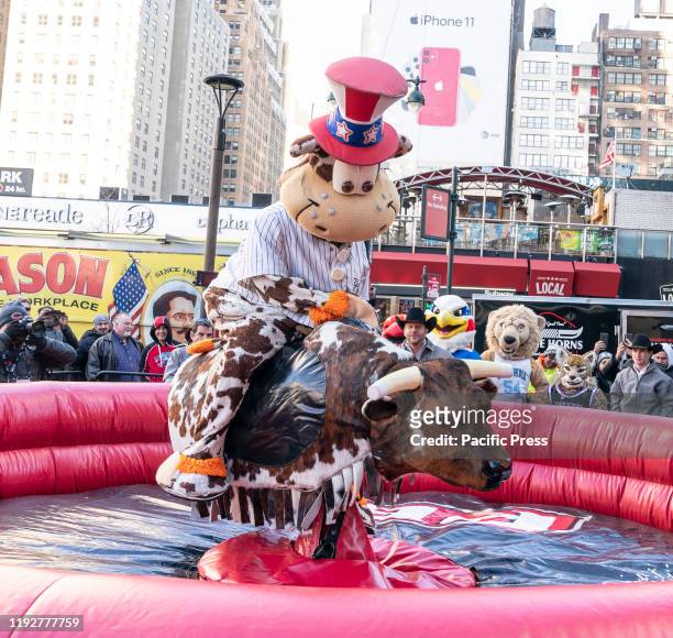 Staten Island Yankees mascot Scooter the Holy Cow rides mechanical bull during Professional Bull Riders launch of season 2020 outside of Madison...