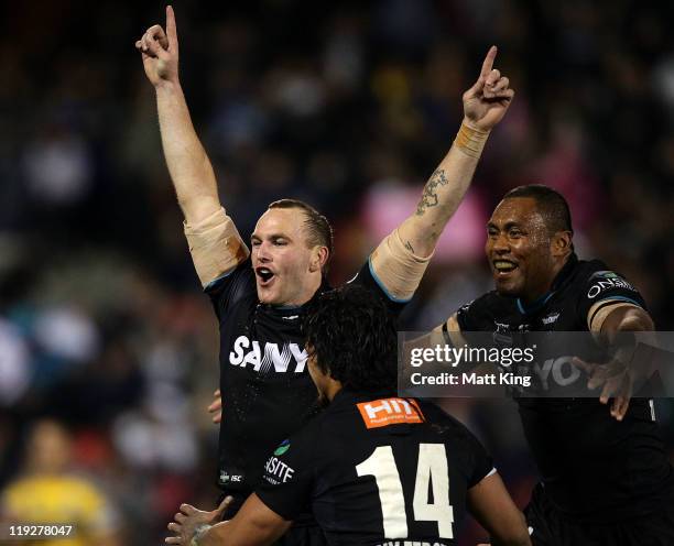 Luke Walsh of the Panthers celebrates with team mates after kicking the match winning field goal in extra time during the round 19 NRL match between...