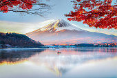 Fuji Mountain , Red Maple Tree and Fisherman Boat with Morning Mist in Autumn, Kawaguchiko Lake, Japan