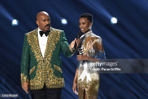 Steve Harvey and Miss South Africa Zozibini Tunzi speak onstage at the 2019 Miss Universe Pageant at Tyler Perry Studios on December 08, 2019 in...