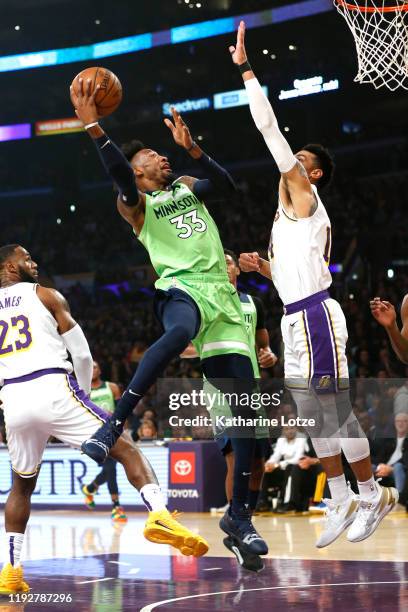 Robert Covington of the Minnesota Timberwolves shoots the ball as Danny Green of the Los Angeles Lakers defends during the first half at Staples...