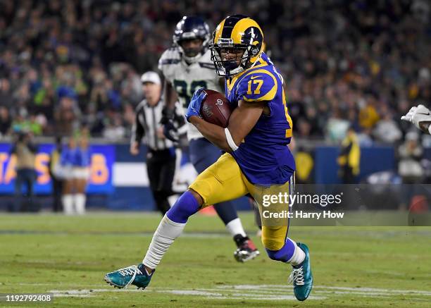 Wide receiver Robert Woods of the Los Angeles Rams caries the ball over the defense of the Seattle Seahawks during the game at Los Angeles Memorial...