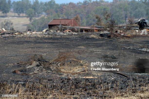 Debris lies strewn across a property burned out by wildfires in Buchan, East Gippsland, Australia, on Thursday, Jan. 9, 2020. Dozens of communities...