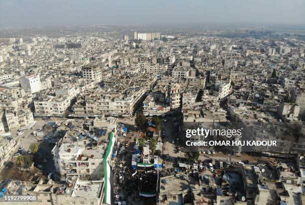 An aerial view shows Syrians demonstrating against the regime of Bashar al-Assad on January 10, 2020 in the northwestern Idlib province, Syria's last...